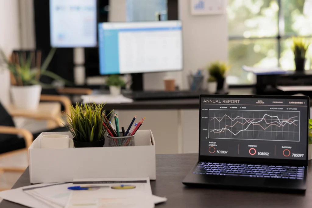 image from the office with a laptop saying annual report on the screen